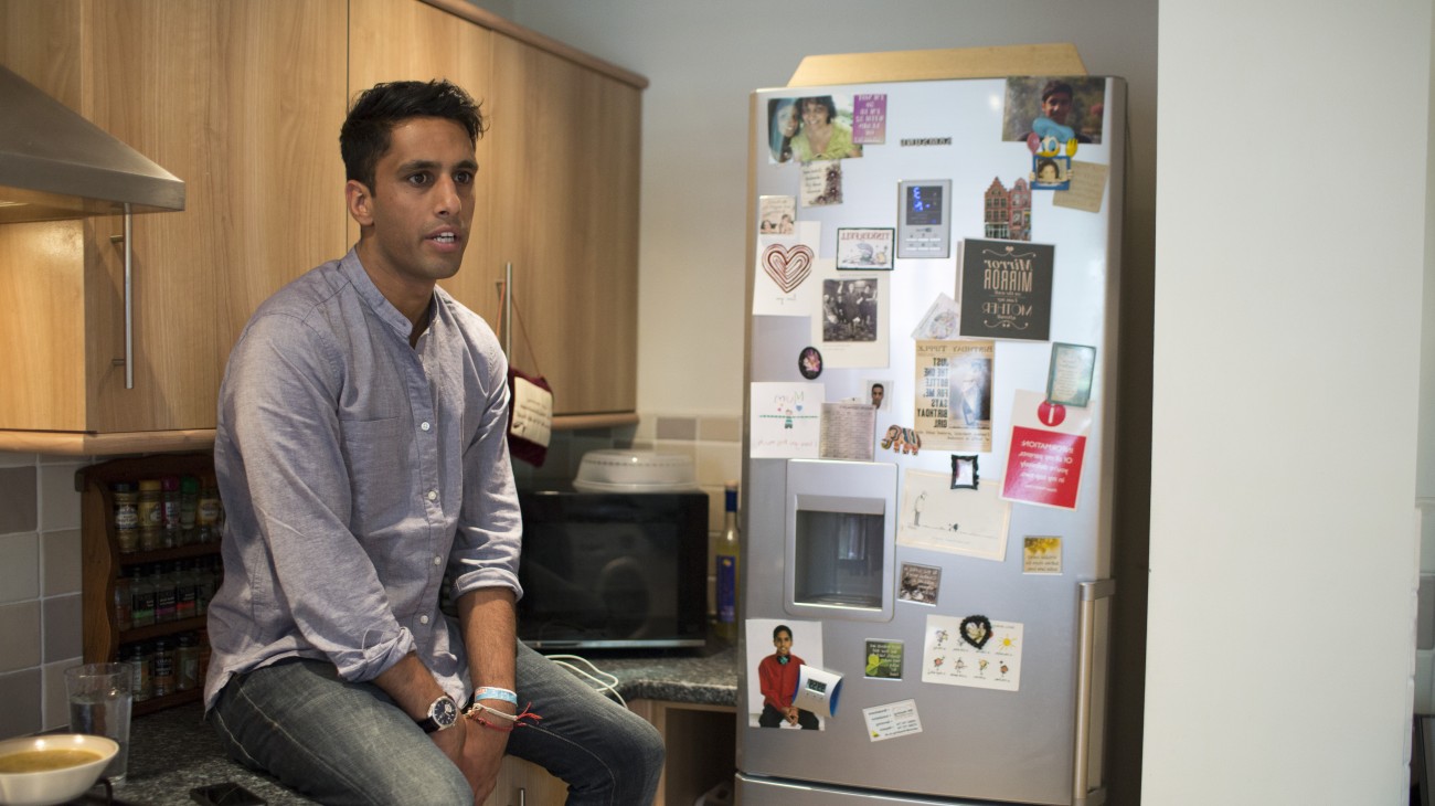 Amrik sitting in his kitchen 