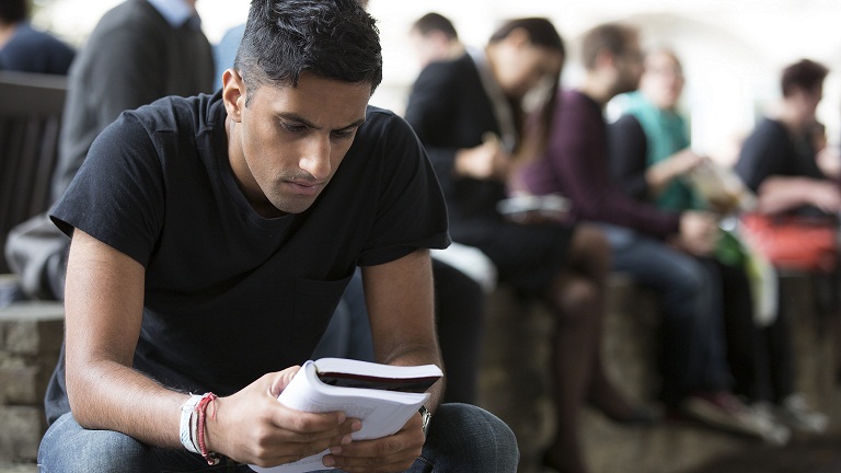 Amrik reading a book