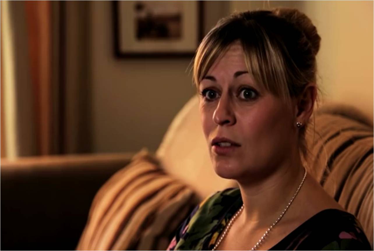 Kate being interviewed sat on her sofa