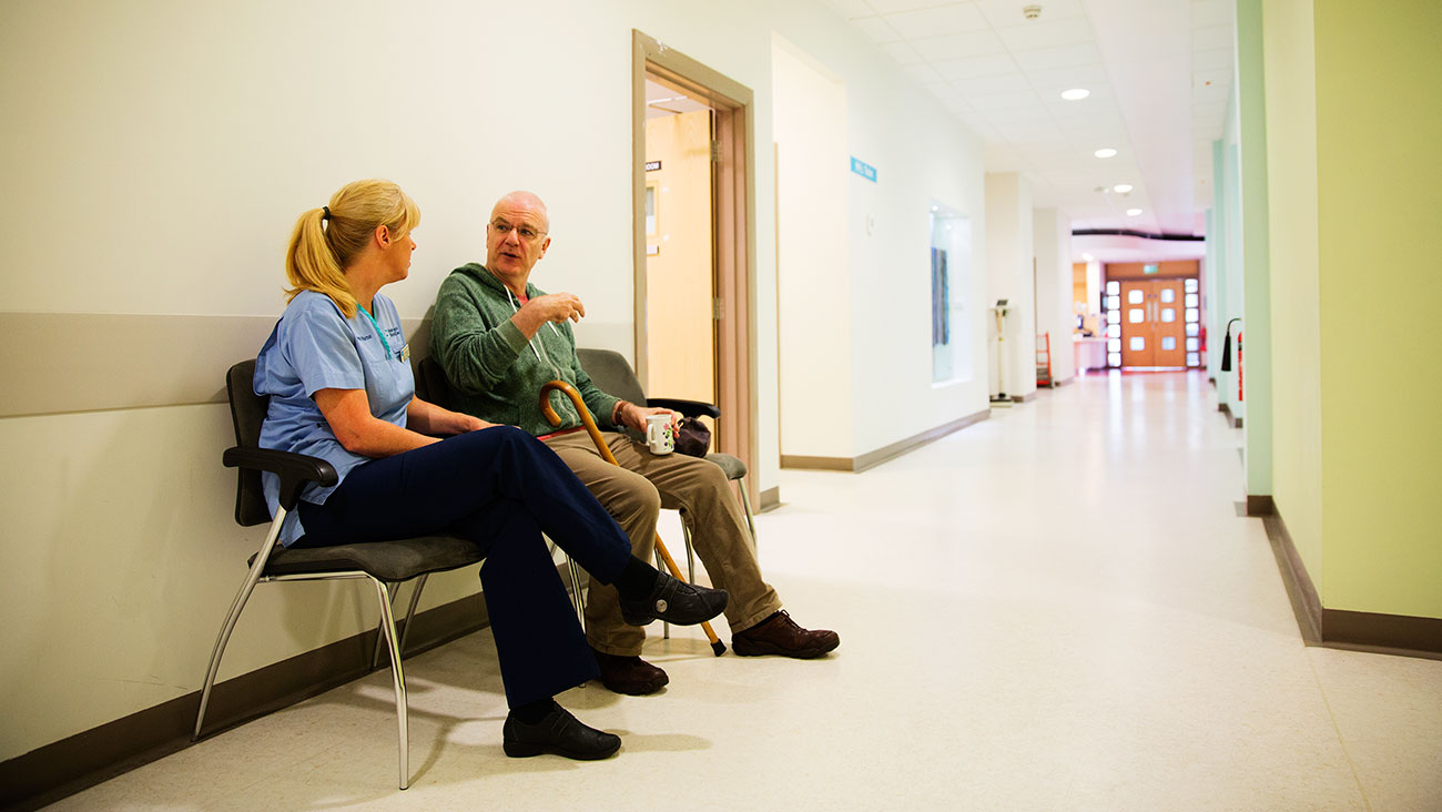 Gary sits in the hospital with his Macmillan nurse