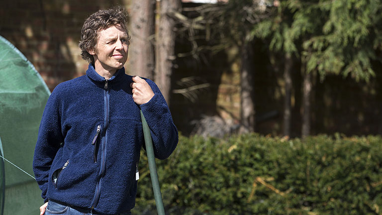 Ashley smiling with the sun on his face in the garden