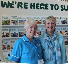 Supporters smiling standing in a cancer information centre in the East Midlands.