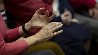Gesticulating hands close up at a support group