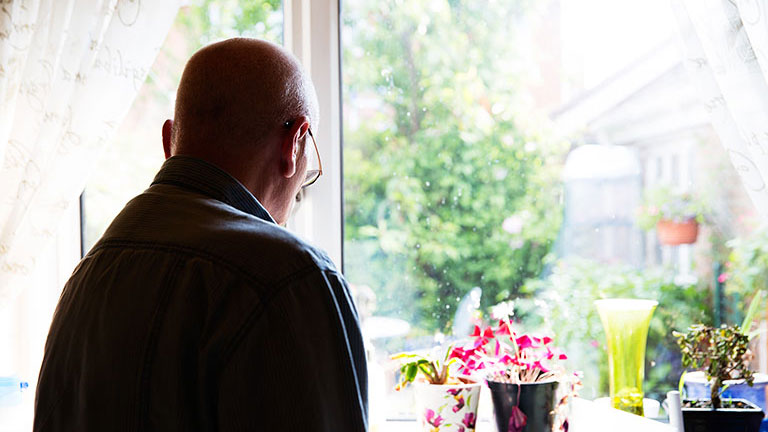 Gary stares out of his window in the kitchen 