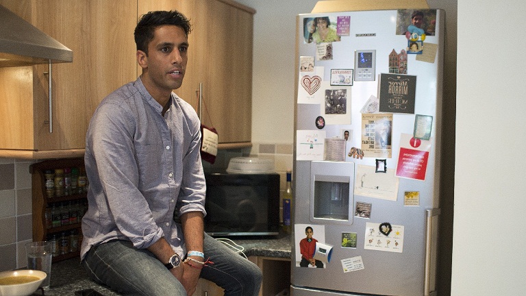 Amrik sitting in his kitchen 
