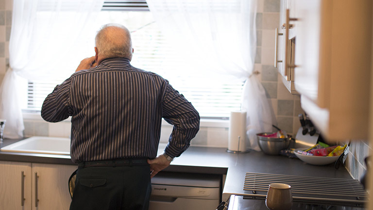 Bill stares out of the window drinking tea in his kitchen