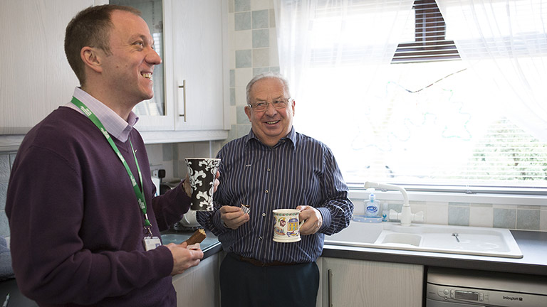 Bill and Tony share drink tea in the kitchen 