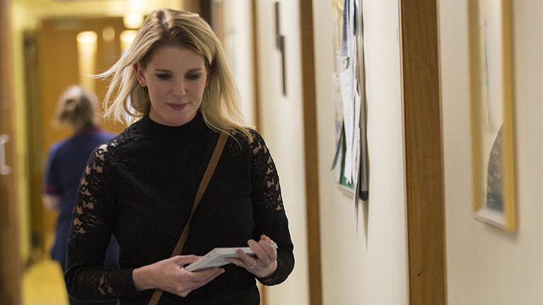 Lindsey walking through the hospital corridor