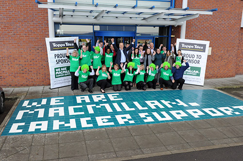 Our Partnership With Topps Tiles Working Us Macmillan A Group Of Topps Tiles Employees Stand Outside With We Are Macmillan Cancer Support
