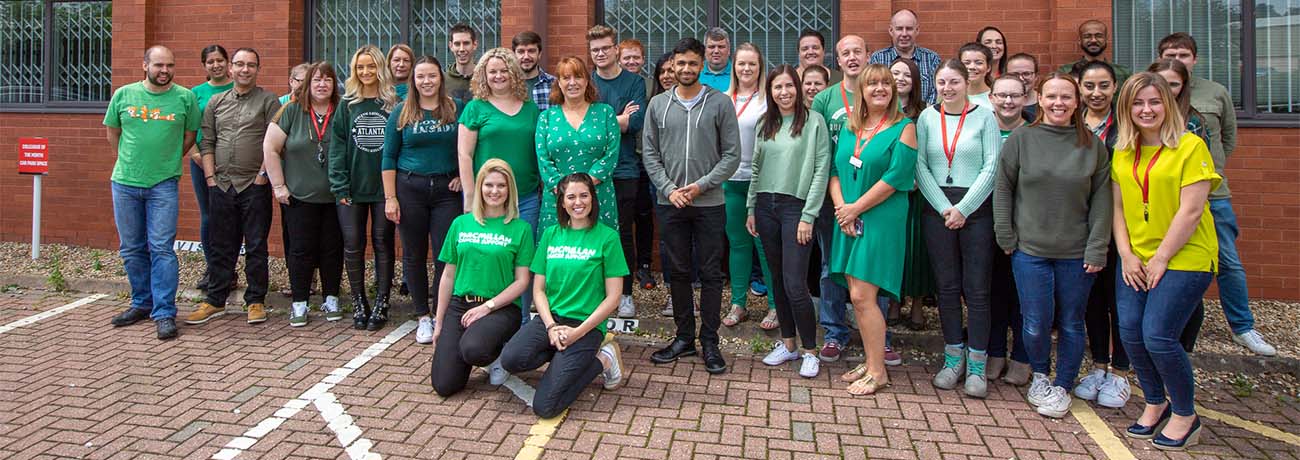 Staff from Everyone Active wearing green to support Macmillan