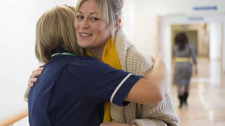 Kate hugs a Macmillan nurse