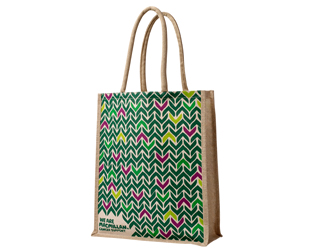 A brown tote bag with a multicoloured chevron pattern and a small Macmillan logo at the bottom.