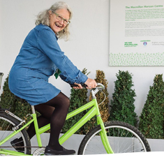 A support smiling on a bike outside of the Horizon Center, Brighton.