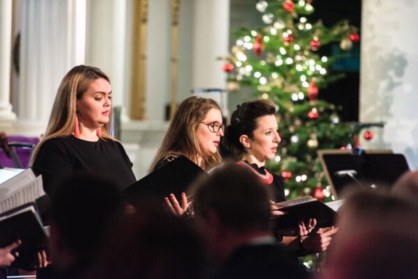 Three women singer at a carol service