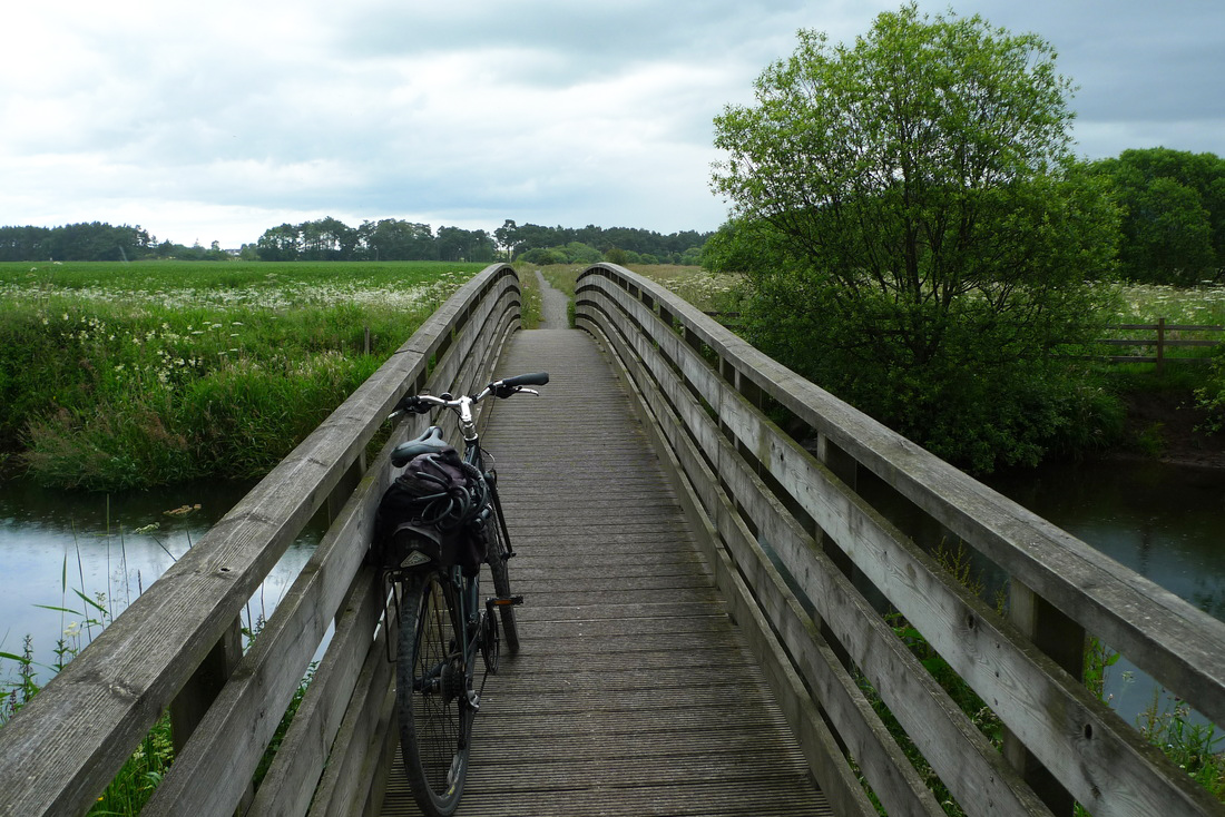 A bike propped against a bridge on the Loch Leven cycle path