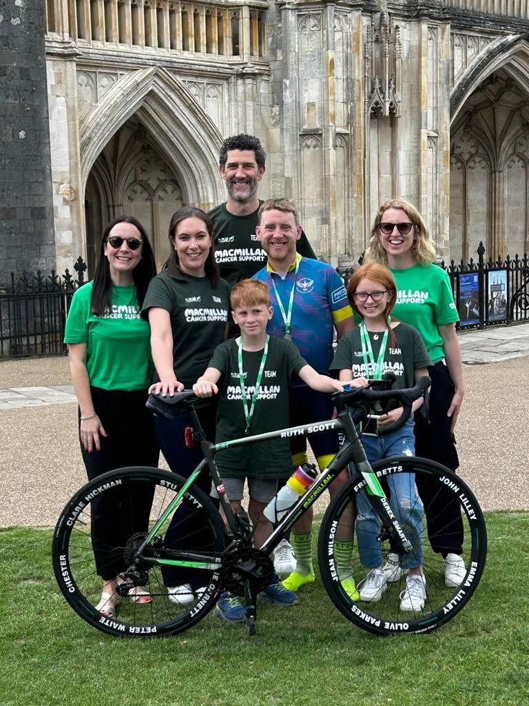 Simon at the finish of his challenge with his bike and supporters