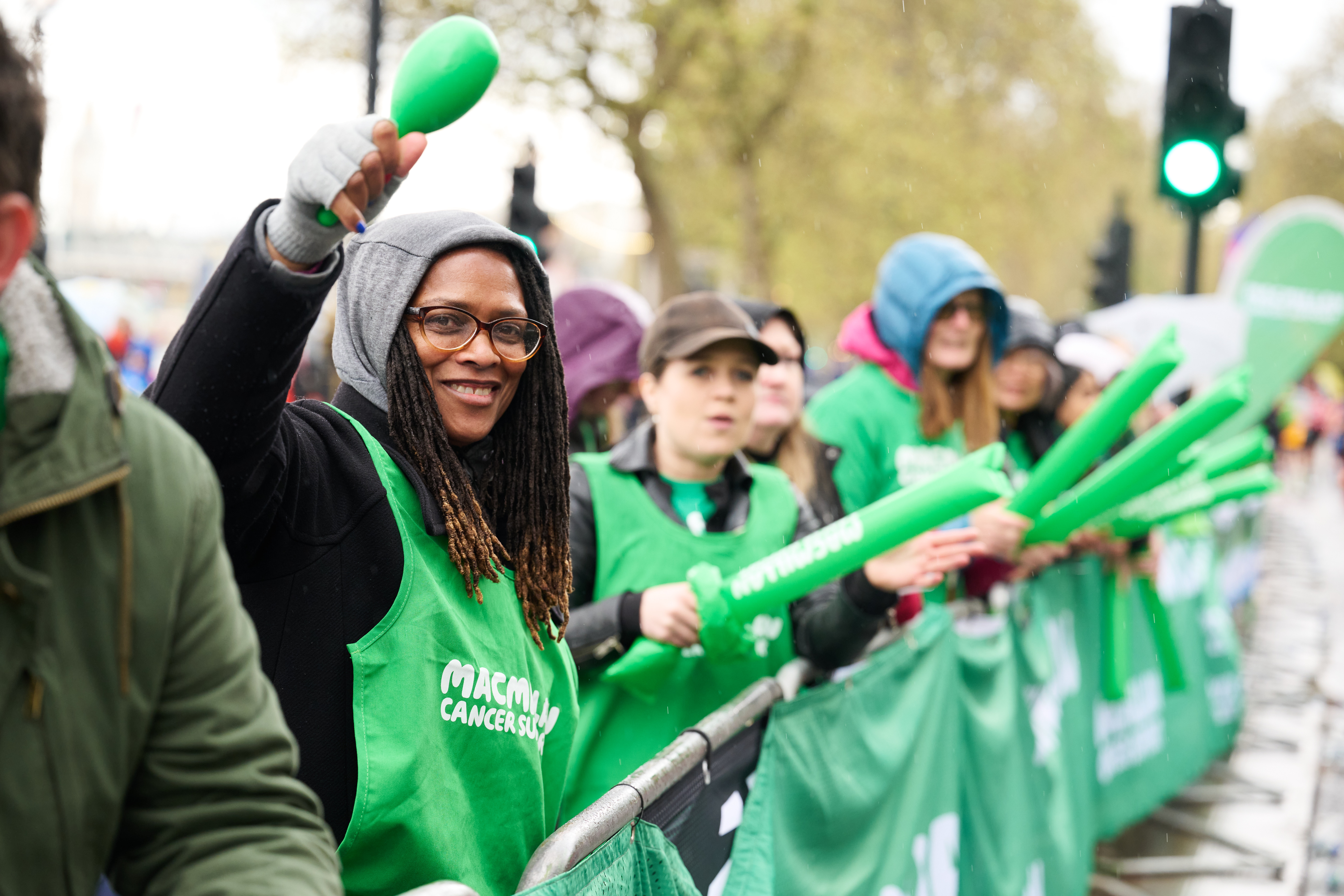 Macmillan supporters at an event at the side of the road cheering people on