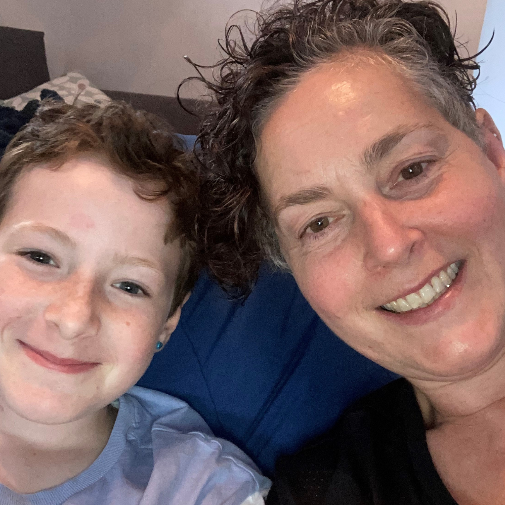 A child with their mum smiling.