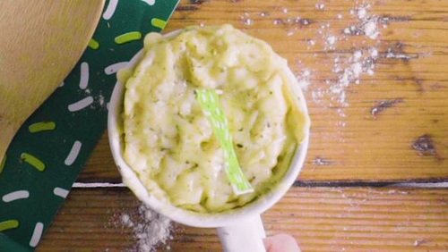 A cheese muffin in a mug fresh from the microwave