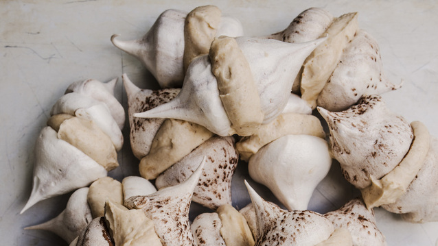 A tempting pile of crisp, airy meringues stuck together with a sweet and fluffy chestnut spread. Some are lightly dusted with cocoa powder, and their delicate swirls and peaks give them a light, melt-in-the-mouth look.