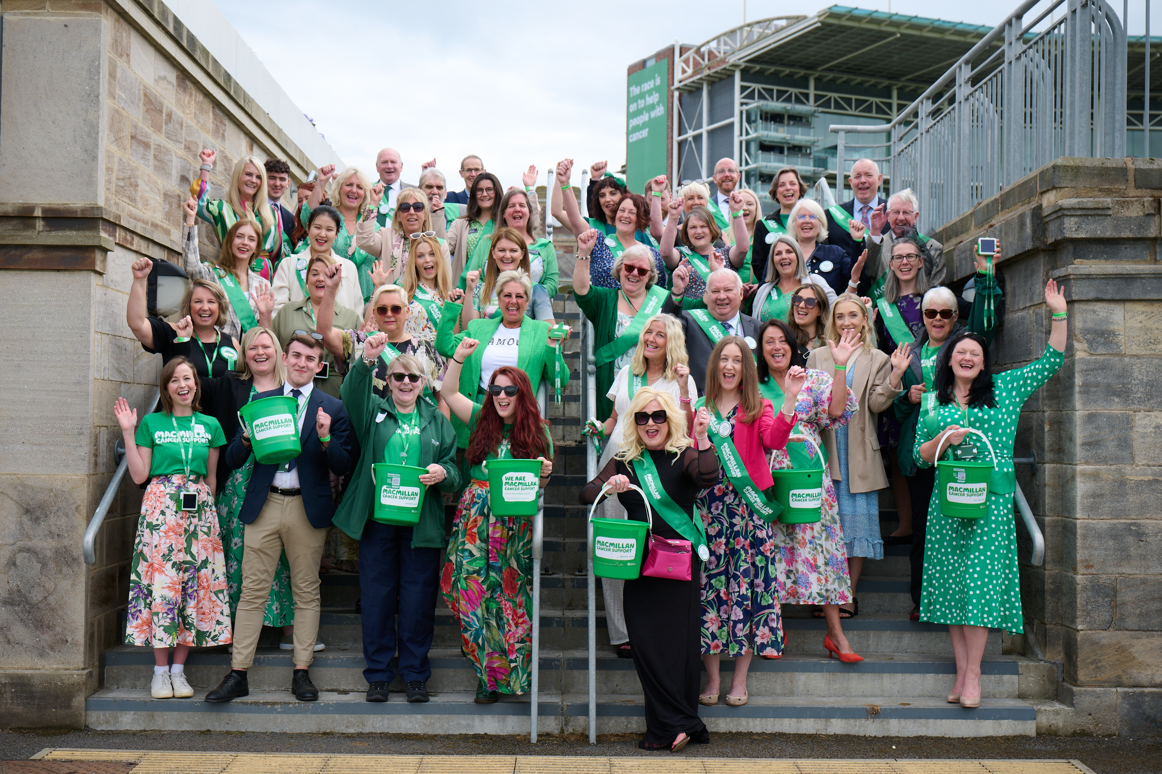 Lots of Macmillan supporters on stairs at the Macmillan Raceday