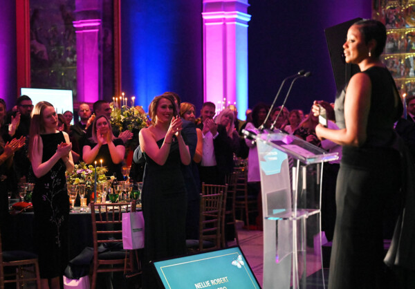 People standing and clapping a presenter at the Macmillan Ball