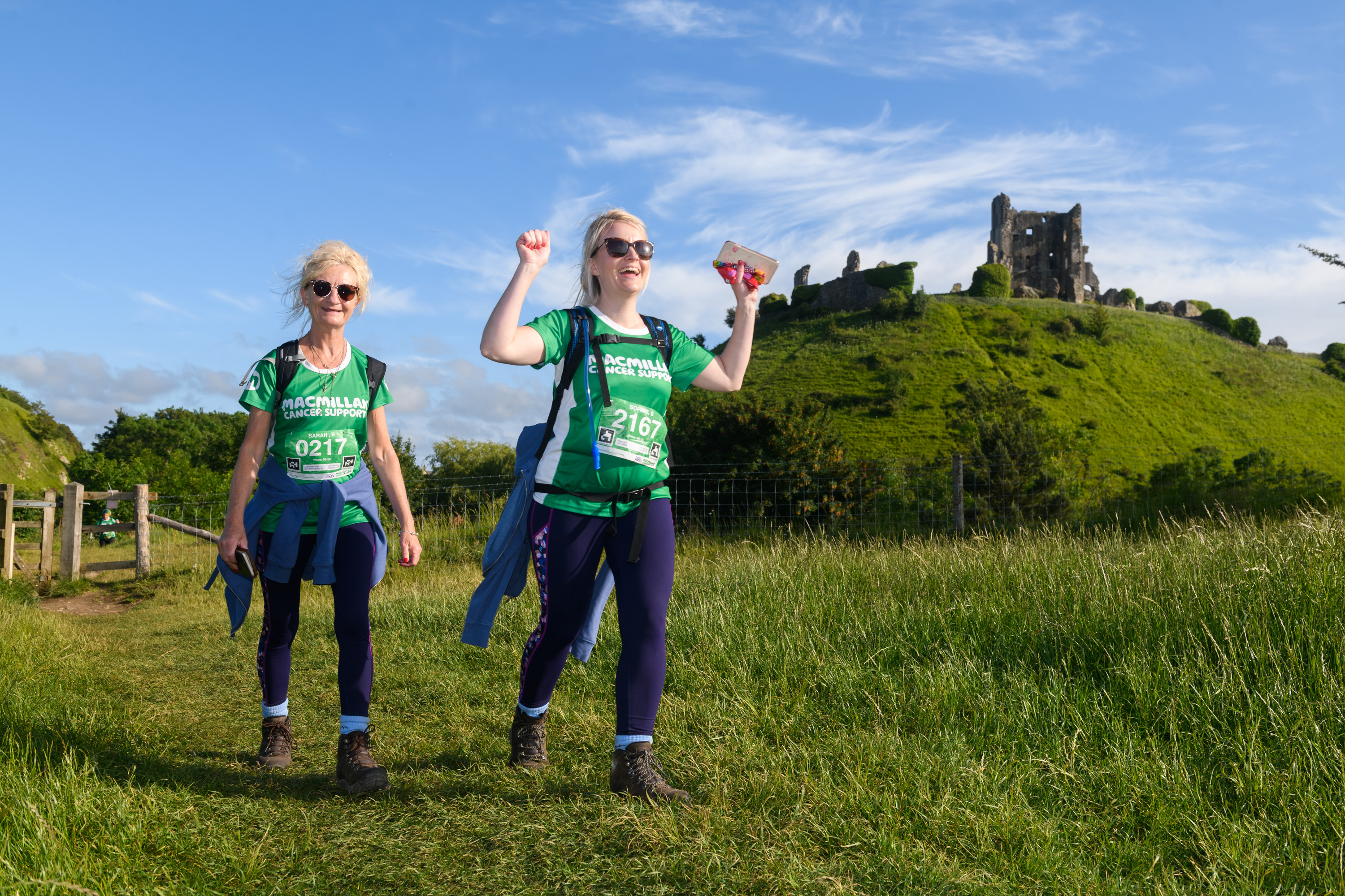 Hikers waving at the camera during Jurassic Coast Mighty Hike