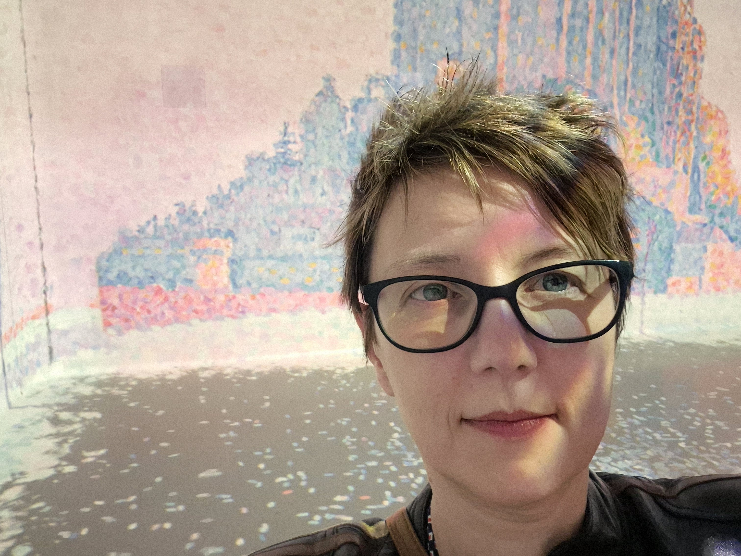 Person with glasses looking at the camera