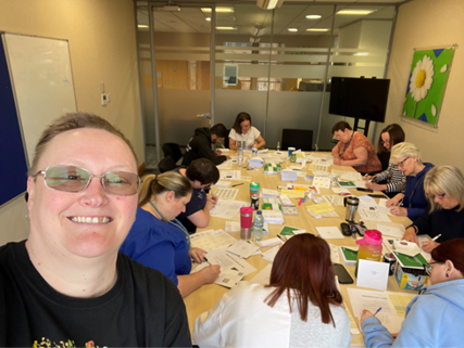 Scottish Widows volunteers sat around an office meeting room desk