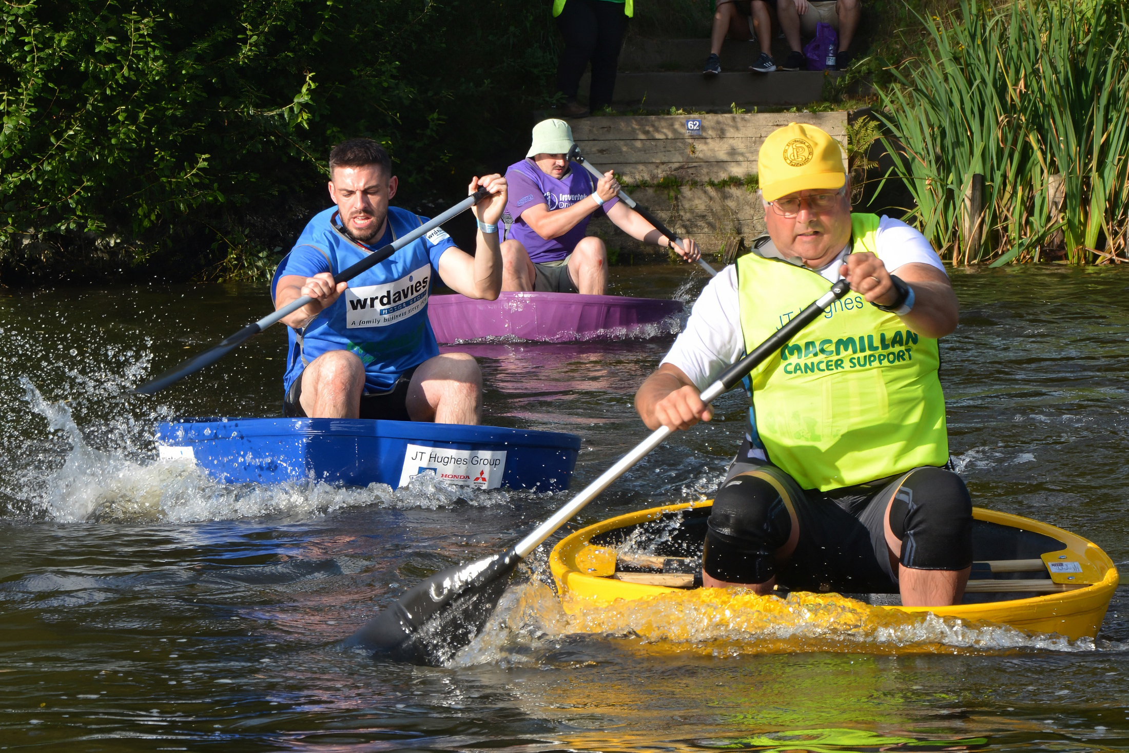 People paddling their coracles