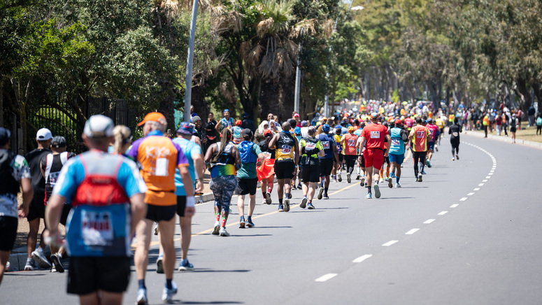 A group of runners participating in a marathon. They are running along a road. ©Mark Sampson