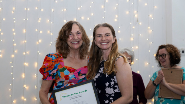 Siobhan MacAndrew, runner-up for the Macmillan Thanks to You Award - Lived Experience  2025 holding her certificate. Photographed with event host Erin Kennedy OBE on the right.