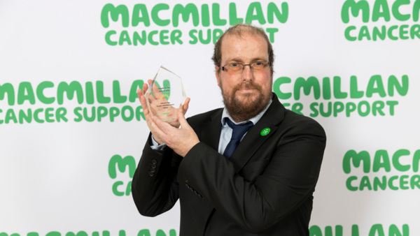 Nathaniel Dye, winner of the 2025 Douglas Macmillan Award holding his award.