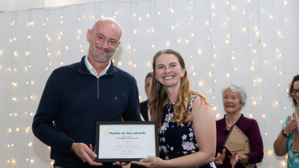 Ben Dobson Outstanding Supporter Runner-up in the Macmillan Thanks to You Awards 2025 holding his certificate. With event host Erin Kennedy OBE on the right.