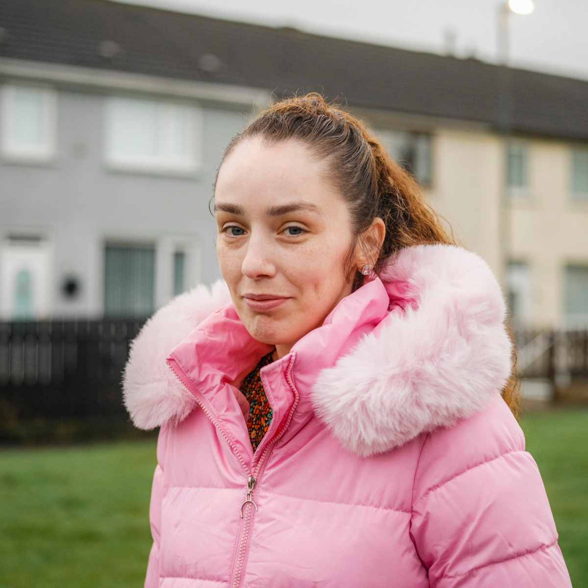 Storyteller Jess, in a pink padded coat looking at the camera