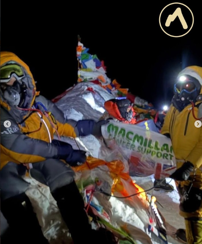 Shaunna with a Macmillan flag on Everest in full climbing gear
