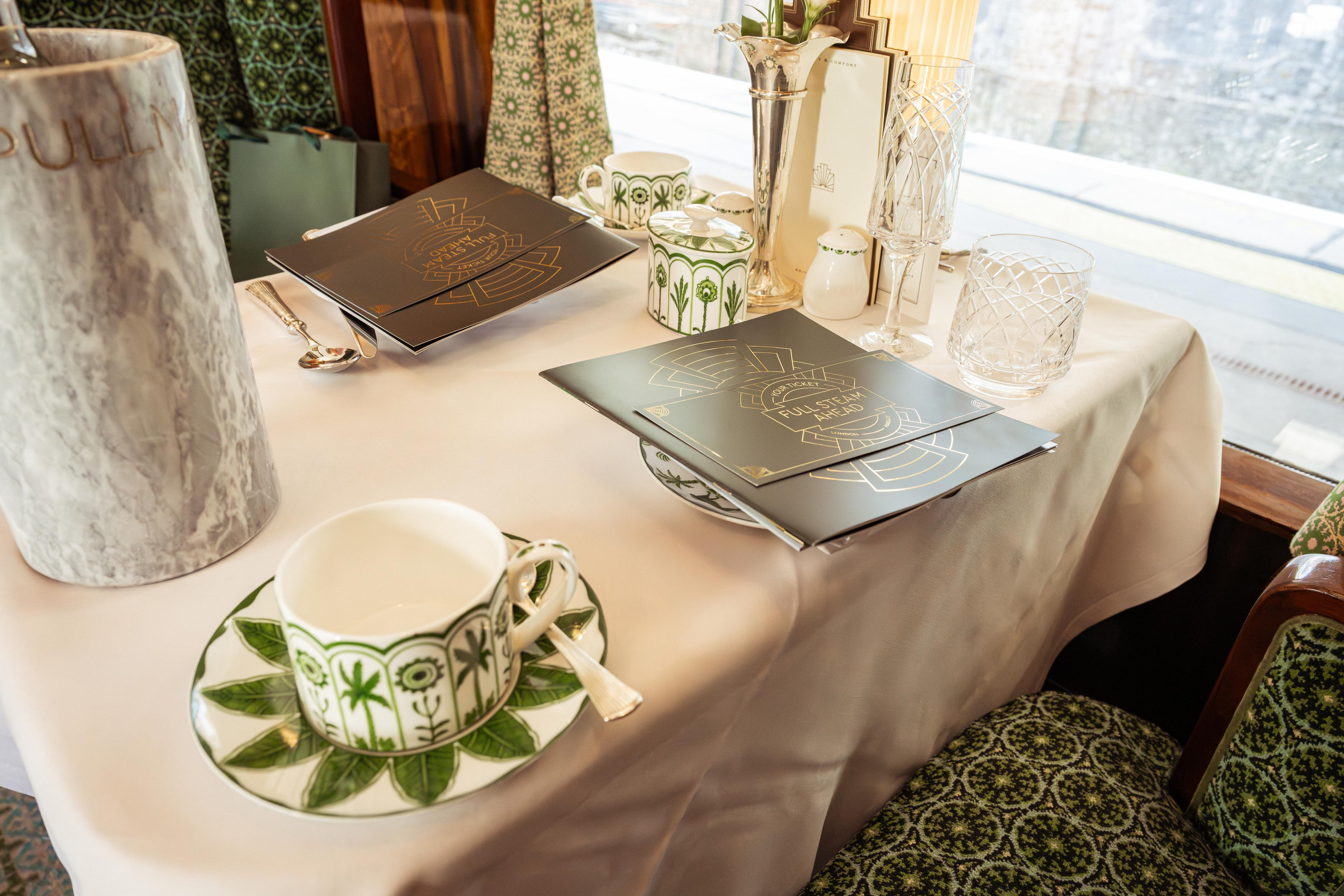 A table on the train with cup and saucer and menus on