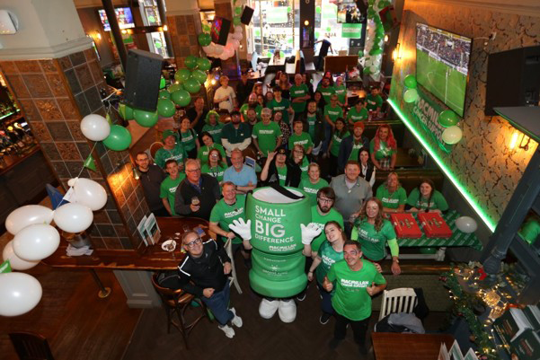 A group of fundraisers standing inside a Greene King pub.