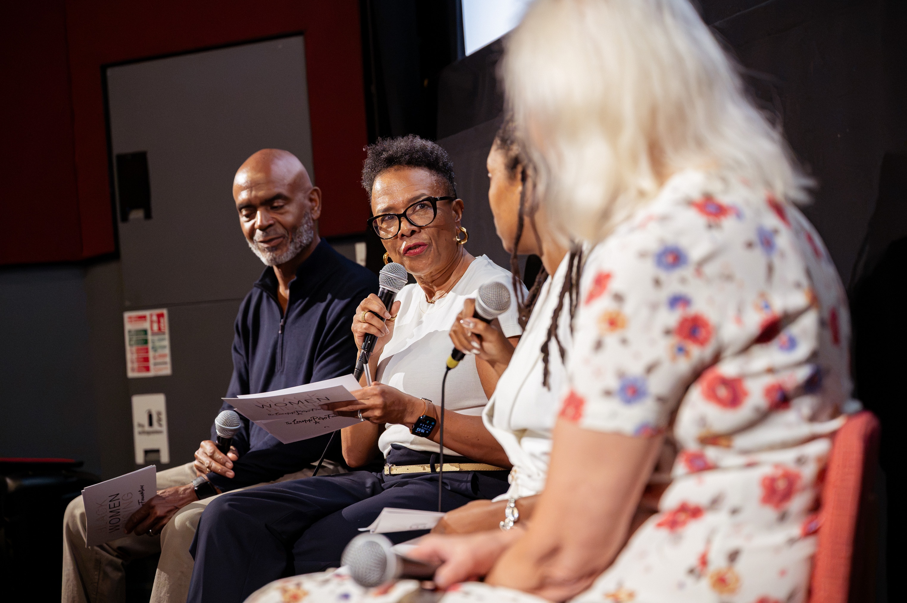 Group of 4 people in a panel discussion at Charlotte's story screening event.