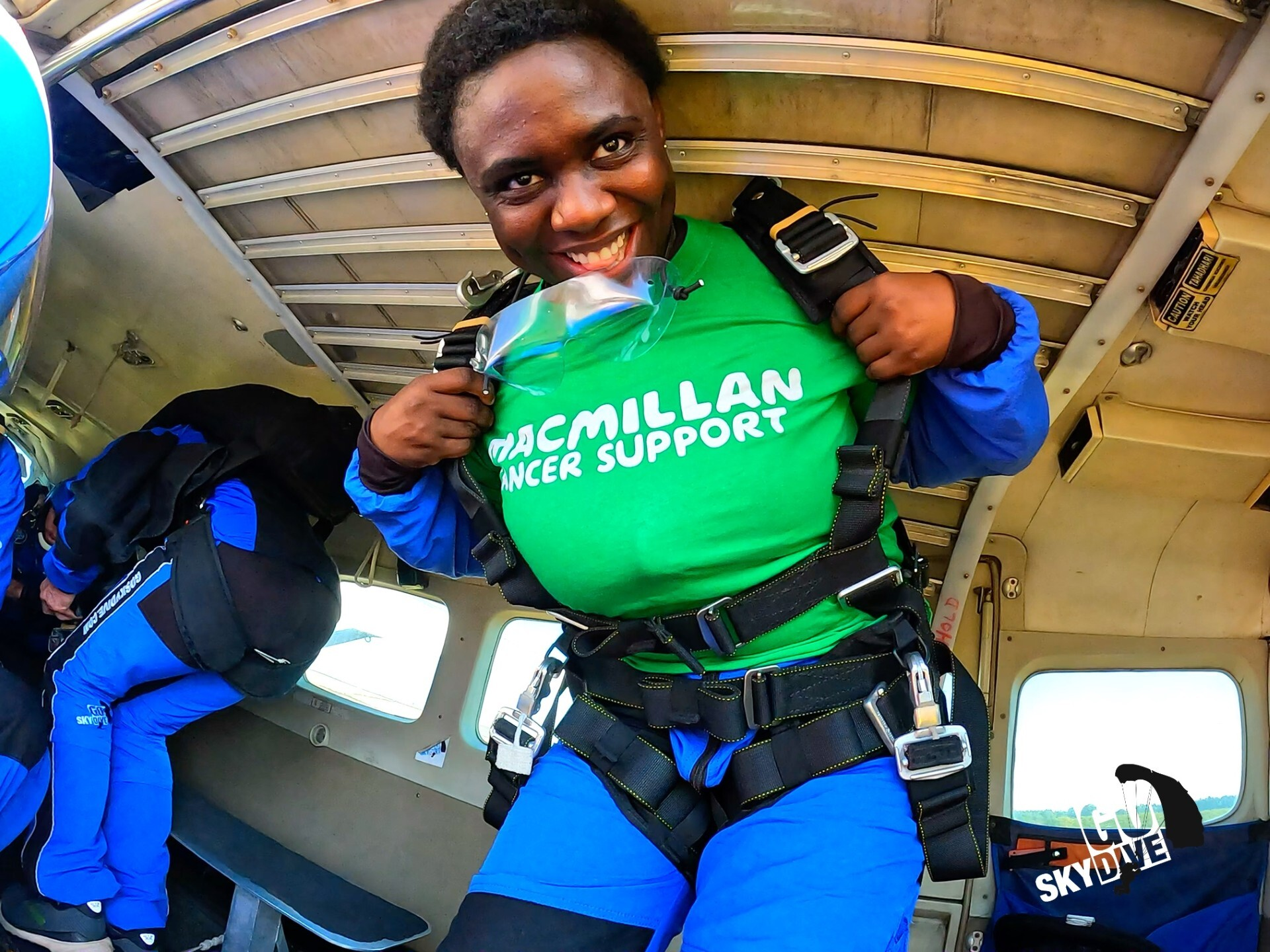 Blessing getting ready to jump in the plane, smiling at the camera