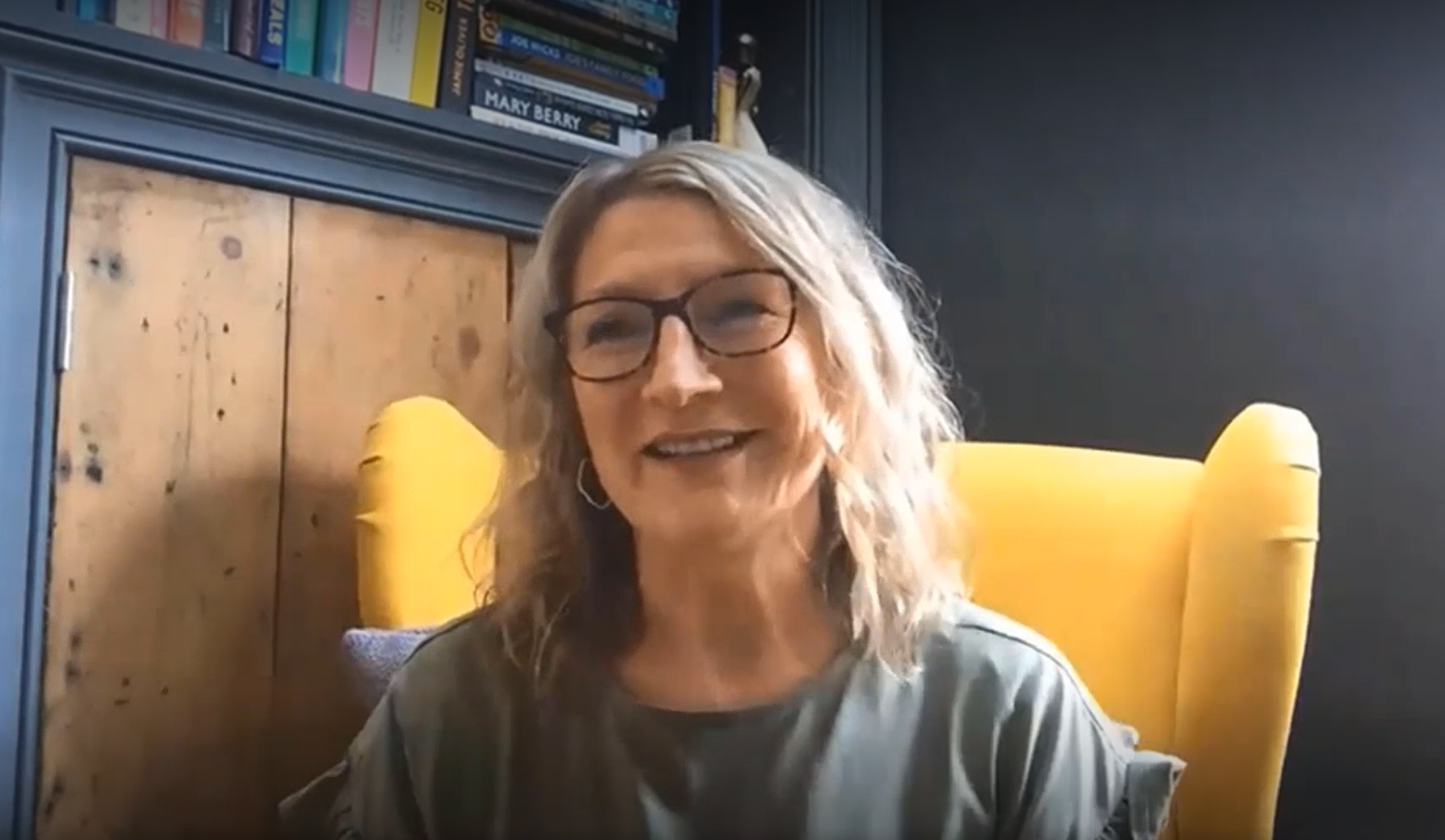 A lady wearing glasses talks about emotional support.